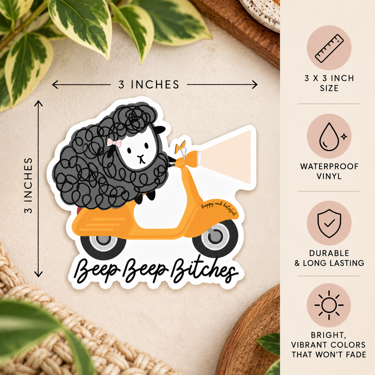 A die-cut vinyl sticker featuring a cartoon sheep with curly black wool driving an orange/yellow scooter, with the text 'Beep Beep Bitches' below. The sticker is shown on a beige surface with decorative leaves and a wooden bowl, with measurement arrows indicating 3 x 3 inches and a feature callout panel on the right.