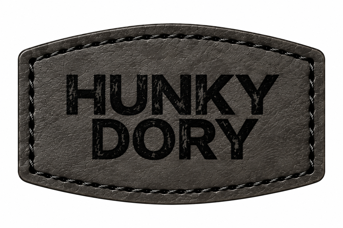 A black patch with stitched borders and the text 'HUNKY DORY' printed in black distressed lettering, shown on a plain white background.