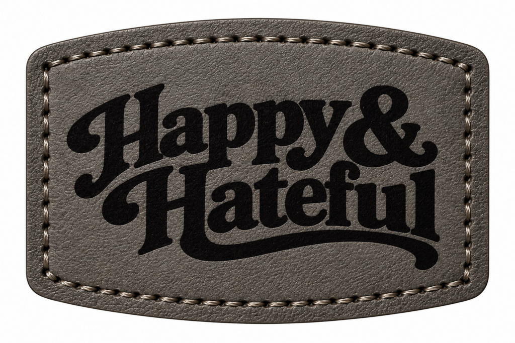 A black textured leather patch with rounded corners, featuring the words 'Happy & Hateful' in a black decorative script font, bordered by light stitching.