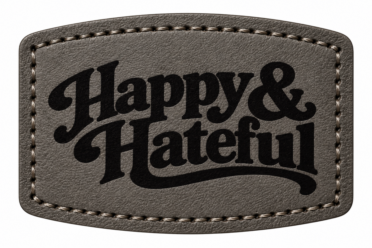A black textured leather patch with rounded corners, featuring the words 'Happy & Hateful' in a black decorative script font, bordered by light stitching.