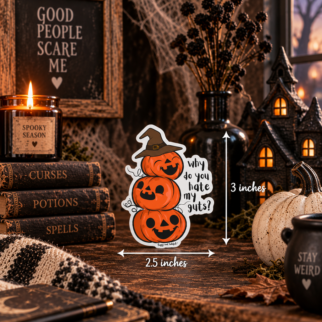 A Halloween-themed die-cut sticker featuring three stacked jack-o'-lanterns with a witch hat and the text 'Why do you hate my guts?' shown on a tabletop with spooky decor. White dimension arrows indicate the sticker.