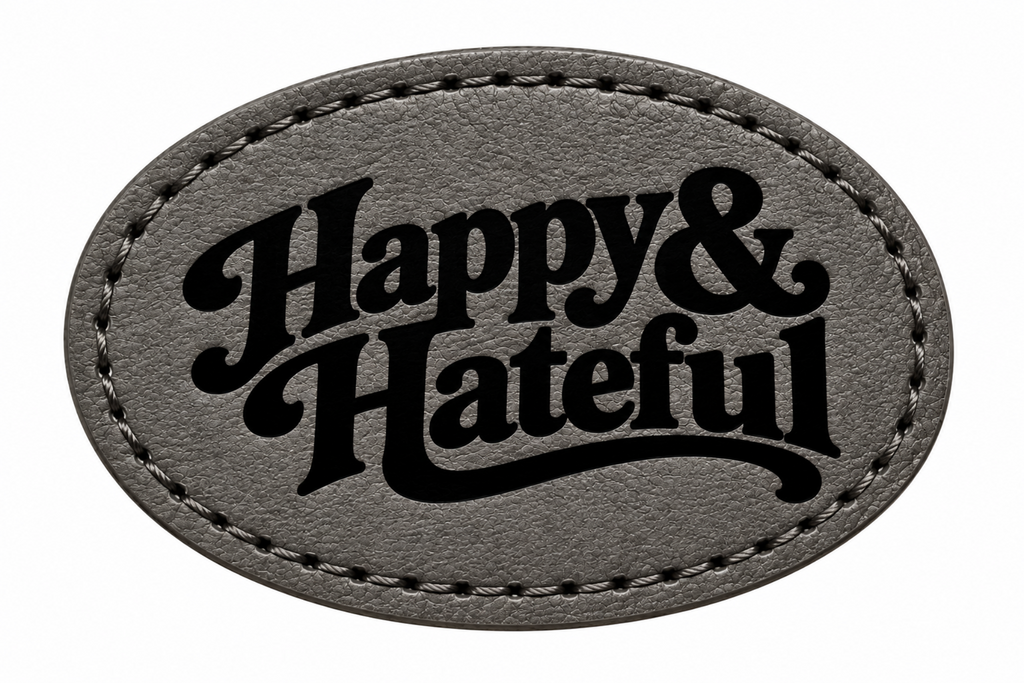 An oval-shaped black patch with black stitched borders and the words 'Happy & Hateful' in black script, shown on a plain white background.