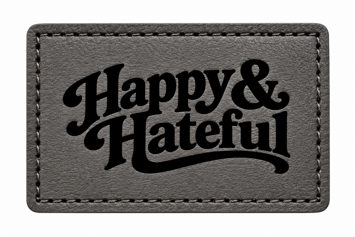 A rectangular black patch with black stitched borders and the words 'Happy & Hateful' in large black script across the front, shown on a plain white background.