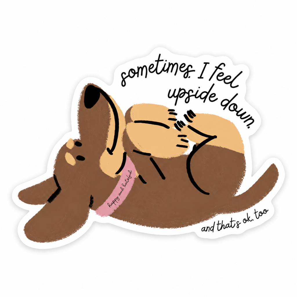 A die-cut sticker featuring a cartoon dog lying upside down with the text 'sometimes I feel upside down. and that's ok, too'.